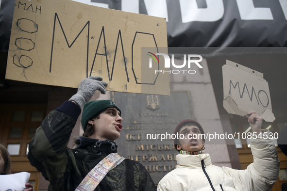 Demonstrators are holding placards as they demand an increase in financial support for the Armed Forces of Ukraine outside the Kyiv City Sta...