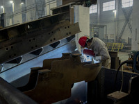 A worker is working at a workshop of a manufacturing enterprise in Hai'an, Jiangsu Province, China, on December 14, 2023. (