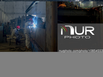 A worker is working at a workshop of a manufacturing enterprise in Hai'an, Jiangsu Province, China, on December 14, 2023. (