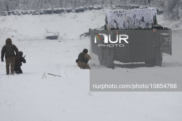 Servicemen are exercising with an APC while senior sergeants from the units of the Eastern Operational and Territorial Command of the Nation...