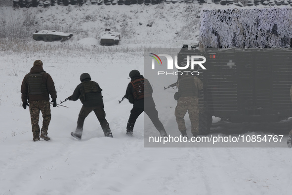 Servicemen are exercising with an APC while senior sergeants from the units of the Eastern Operational and Territorial Command of the Nation...