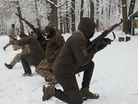Servicemen are exercising with rifles while senior sergeants from the units of the Eastern Operational and Territorial Command of the Nation...