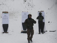 Servicemen are practicing at a shooting range while senior sergeants from the units of the Eastern Operational and Territorial Command of th...