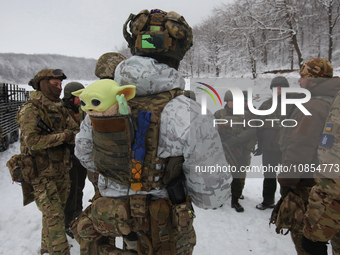 In Kharkiv Region, Ukraine, on December 14, 2023, a serviceman is carrying a Baby Yoda toy in the pocket at the back of his bulletproof vest...