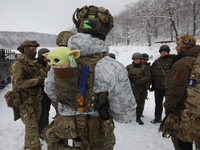 In Kharkiv Region, Ukraine, on December 14, 2023, a serviceman is carrying a Baby Yoda toy in the pocket at the back of his bulletproof vest...