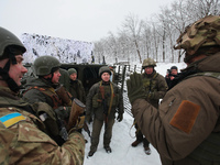 Servicemen are listening to an instructor as senior sergeants from the units of the Eastern Operational and Territorial Command of the Natio...