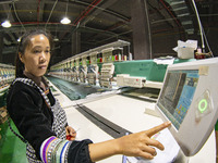 A worker is making embroidery orders at a workshop of a textile enterprise in Congjiang County, Guizhou Province, China, on December 15, 202...