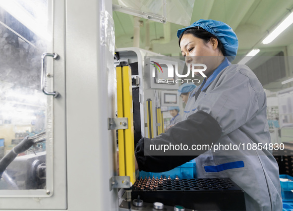 A worker is producing motor products at a motor production workshop in Nantong, Jiangsu Province, China, on December 15, 2023. 