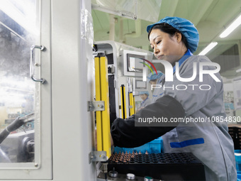 A worker is producing motor products at a motor production workshop in Nantong, Jiangsu Province, China, on December 15, 2023. (