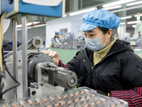 A worker is producing motor products at a motor production workshop in Nantong, Jiangsu Province, China, on December 15, 2023. (