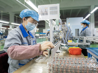 A worker is producing motor products at a motor production workshop in Nantong, Jiangsu Province, China, on December 15, 2023. (