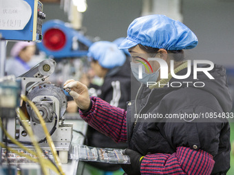 A worker is producing motor products at a motor production workshop in Nantong, Jiangsu Province, China, on December 15, 2023. (