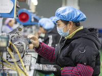 A worker is producing motor products at a motor production workshop in Nantong, Jiangsu Province, China, on December 15, 2023. (