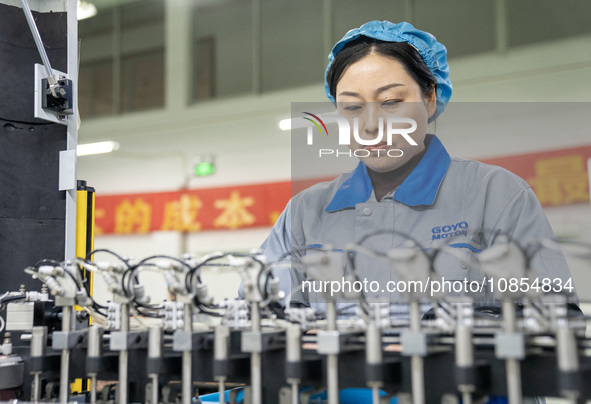 A worker is producing motor products at a motor production workshop in Nantong, Jiangsu Province, China, on December 15, 2023. 