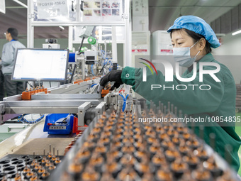 A worker is producing motor products at a motor production workshop in Nantong, Jiangsu Province, China, on December 15, 2023. (