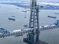 Builders are working in the snow at the construction site of the Changtai Yangtze River Bridge in Taixing, Jiangsu Province, East China, on...