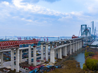 Builders are working in the snow at the construction site of the Changtai Yangtze River Bridge in Taixing, Jiangsu Province, East China, on...