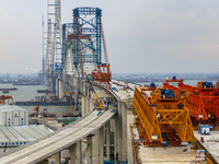 Builders are working in the snow at the construction site of the Changtai Yangtze River Bridge in Taixing, Jiangsu Province, East China, on...