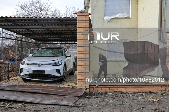 A man is standing by a car that has been damaged by Russian shelling in Odesa Region, southern Ukraine, on December 17, 2023. 