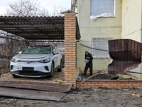 A man is standing by a car that has been damaged by Russian shelling in Odesa Region, southern Ukraine, on December 17, 2023. (