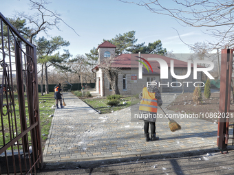 People are cleaning up the rubble after Russian shelling of a residential area in Odesa Region, southern Ukraine, on December 17, 2023. No u...