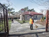 People are cleaning up the rubble after Russian shelling of a residential area in Odesa Region, southern Ukraine, on December 17, 2023. No u...