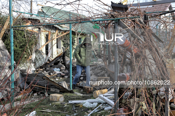 A man is standing outside a house that has been damaged by Russian shelling in the Odesa Region, southern Ukraine, on December 17, 2023. 