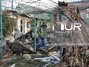 A man is standing outside a house that has been damaged by Russian shelling in the Odesa Region, southern Ukraine, on December 17, 2023. (