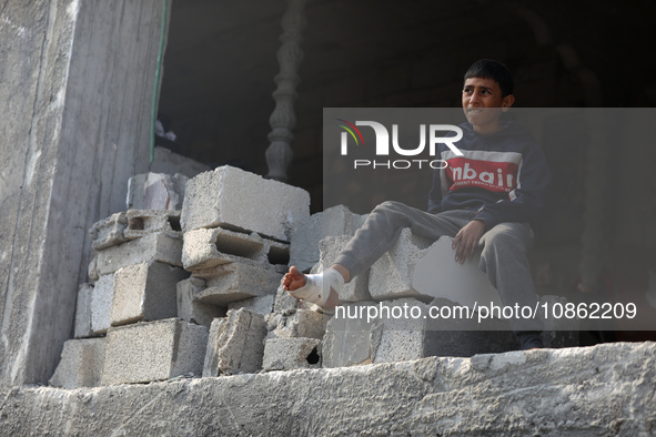 Palestinians are gathering amid the rubble of destroyed buildings following an Israeli bombardment in Deir El-Balah, in the central Gaza Str...