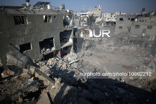 Palestinians are gathering amid the rubble of destroyed buildings following an Israeli bombardment in Deir El-Balah, in the central Gaza Str...