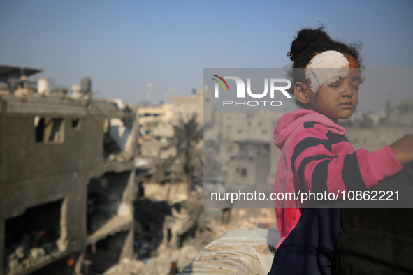 Palestinians are gathering amid the rubble of destroyed buildings following an Israeli bombardment in Deir El-Balah, in the central Gaza Str...