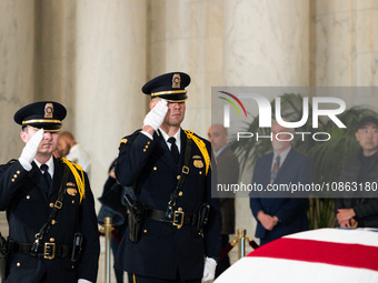 Supreme Court Police officers salute retired Associate Justice Sandra Day O’Connor, the first woman to serve on the Supreme Court, during a...