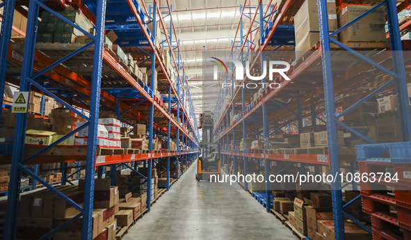 Workers are sorting materials at a warehouse in Huai'an City, Jiangsu Province, China, on December 19, 2023. 