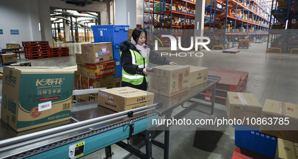 Workers are sorting materials at a warehouse in Huai'an City, Jiangsu Province, China, on December 19, 2023. 