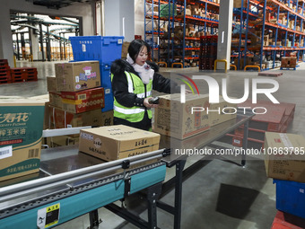 Workers are sorting materials at a warehouse in Huai'an City, Jiangsu Province, China, on December 19, 2023. (