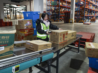 Workers are sorting materials at a warehouse in Huai'an City, Jiangsu Province, China, on December 19, 2023. (