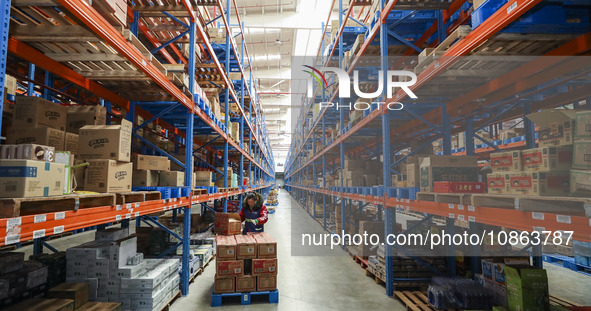 Workers are sorting materials at a warehouse in Huai'an City, Jiangsu Province, China, on December 19, 2023. 