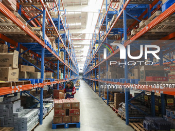 Workers are sorting materials at a warehouse in Huai'an City, Jiangsu Province, China, on December 19, 2023. (