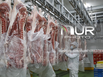 Workers are sorting materials at a warehouse in Huai'an City, Jiangsu Province, China, on December 19, 2023. (