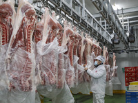 Workers are sorting materials at a warehouse in Huai'an City, Jiangsu Province, China, on December 19, 2023. (