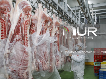 Workers are sorting materials at a warehouse in Huai'an City, Jiangsu Province, China, on December 19, 2023. (