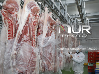 Workers are sorting materials at a warehouse in Huai'an City, Jiangsu Province, China, on December 19, 2023. (