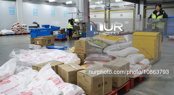 Workers are sorting materials at a warehouse in Huai'an City, Jiangsu Province, China, on December 19, 2023. 