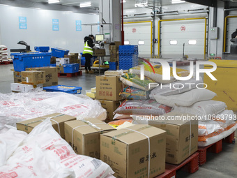 Workers are sorting materials at a warehouse in Huai'an City, Jiangsu Province, China, on December 19, 2023. (