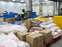 Workers are sorting materials at a warehouse in Huai'an City, Jiangsu Province, China, on December 19, 2023. (