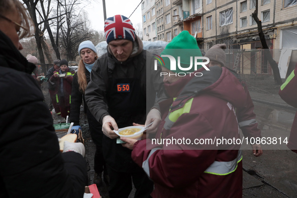 Residents are receiving hot meals and drinks at a temporary warming shelter set up in the yard outside the residential building at 4A Ostafi...