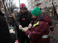 Residents are receiving hot meals and drinks at a temporary warming shelter set up in the yard outside the residential building at 4A Ostafi...