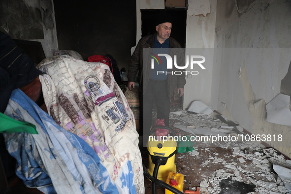 A man is standing inside the damaged apartment of Anatolii Luchok after the residential building at 4A Ostafiia Dashkevycha Street was struc...