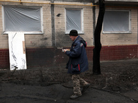 A man is carrying a plastic plate in the yard outside the residential building at 4A Ostafiia Dashkevycha Street in Kyiv, Ukraine, on Decemb...