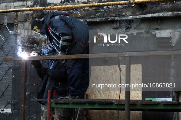 A welder is working on the residential building at 4A Ostafiia Dashkevycha Street in Kyiv, Ukraine, on December 18, 2023, which was damaged...